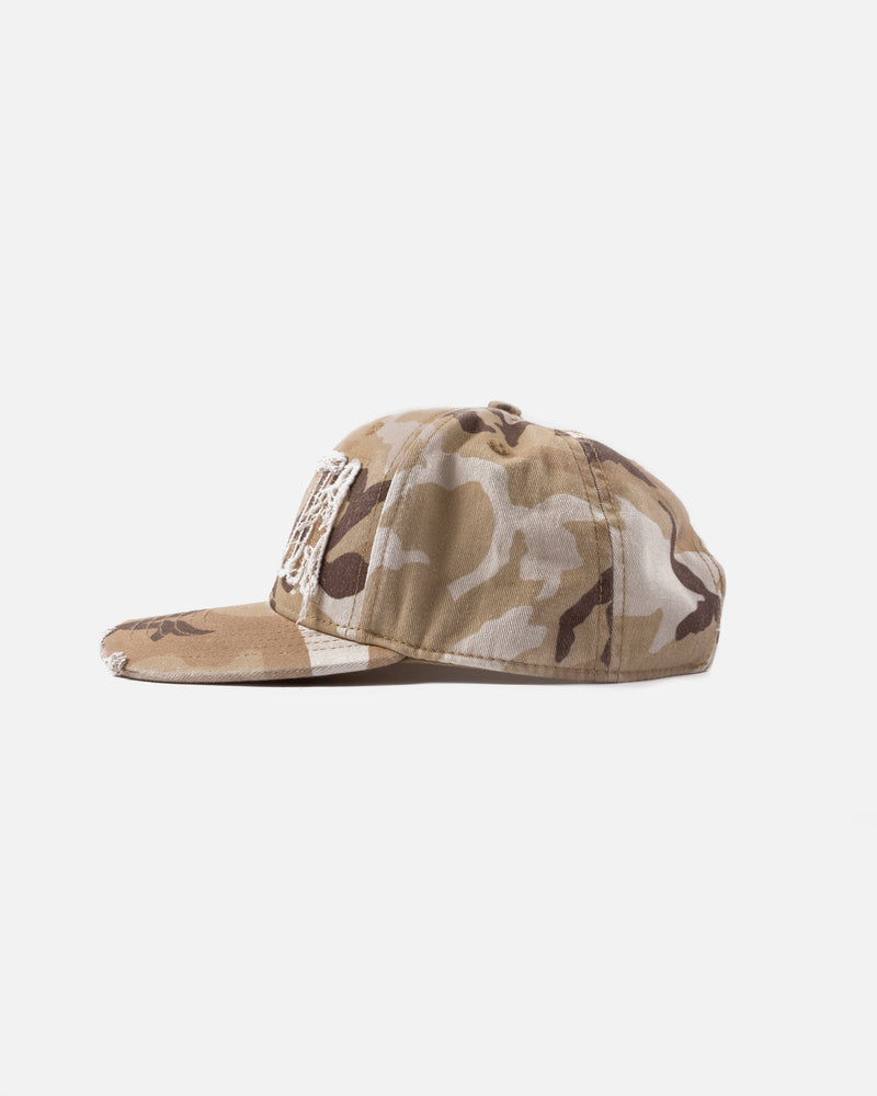 side shot of the frayed woodland camo sports cap