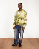 full body model shot of the Peace & Love Knitted Cardigan styled with baggy jeans and boots